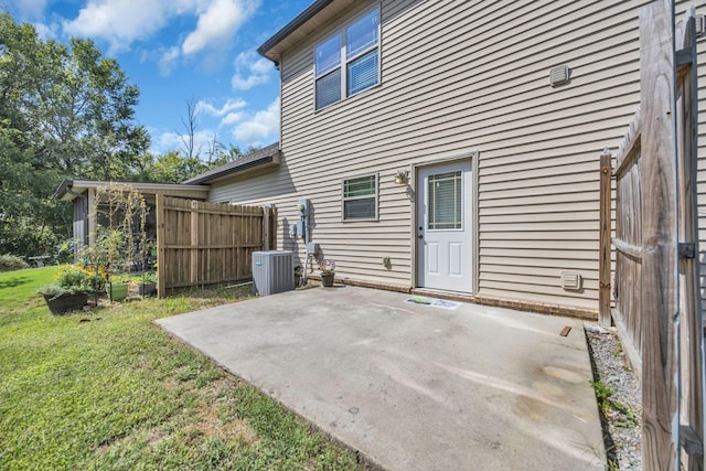 exterior space featuring cooling unit, a yard, and a patio