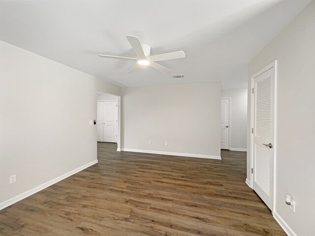 spare room with ceiling fan and dark hardwood / wood-style flooring