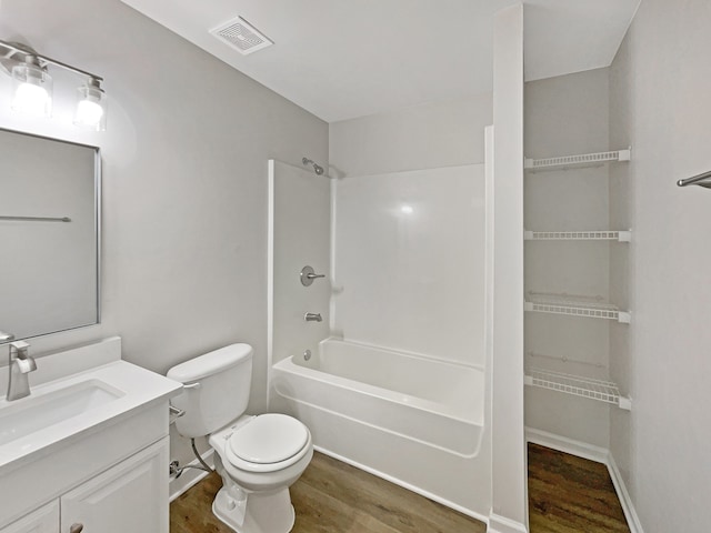 full bathroom featuring tub / shower combination, vanity, toilet, and hardwood / wood-style flooring