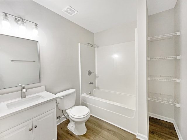 full bathroom with vanity, toilet, shower / bathing tub combination, and hardwood / wood-style flooring