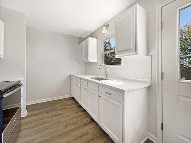 kitchen featuring white cabinetry, stainless steel range with electric stovetop, and a wealth of natural light