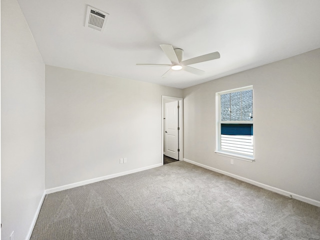 unfurnished room featuring ceiling fan and carpet floors