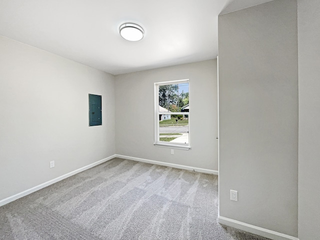 carpeted empty room featuring electric panel