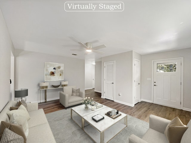 living room with ceiling fan and hardwood / wood-style flooring