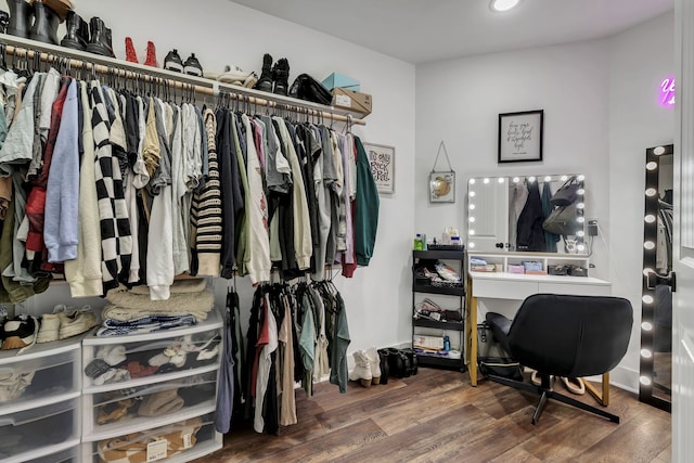 walk in closet with hardwood / wood-style flooring