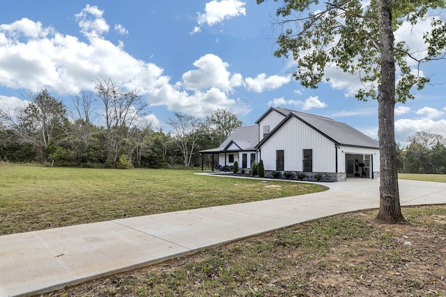 modern farmhouse with a front lawn and a garage