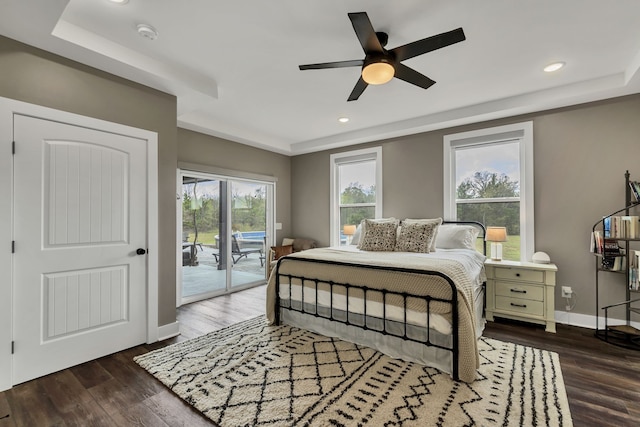 bedroom featuring dark hardwood / wood-style floors, ceiling fan, and access to exterior