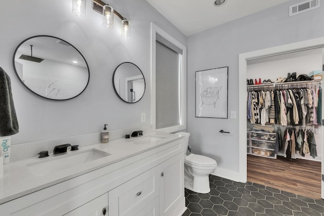 bathroom featuring vanity, hardwood / wood-style floors, and toilet