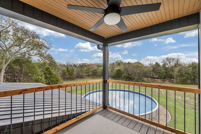 deck with a lawn and ceiling fan