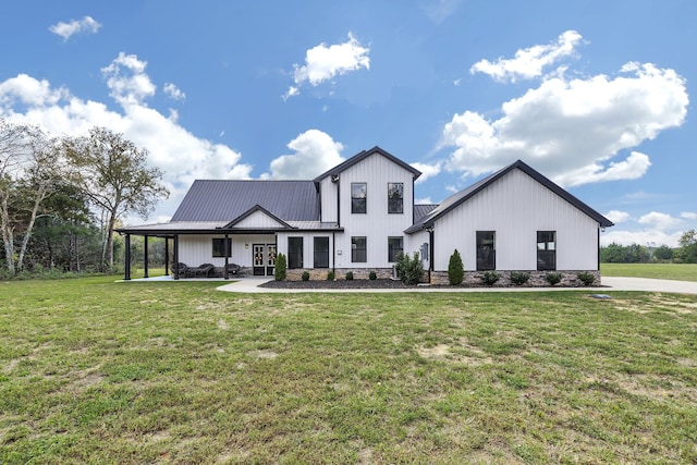 modern farmhouse style home featuring a front yard