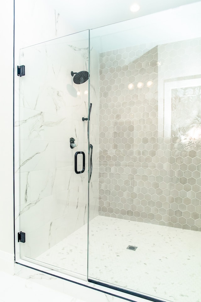 bathroom featuring a shower with door