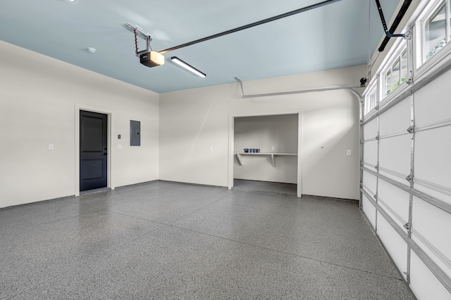 garage featuring a garage door opener and electric panel