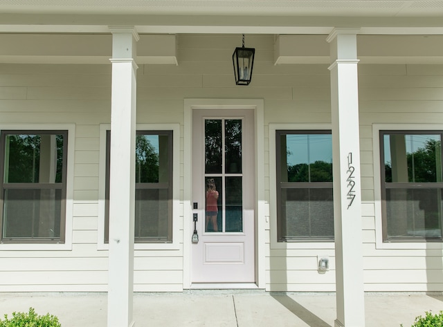 view of exterior entry featuring a porch