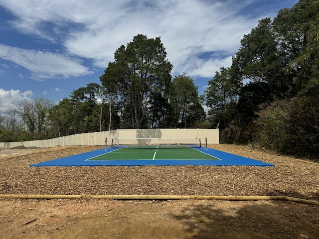 view of property's community with tennis court