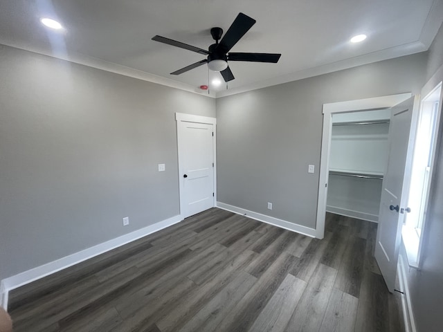 unfurnished bedroom featuring ceiling fan, dark hardwood / wood-style floors, and crown molding