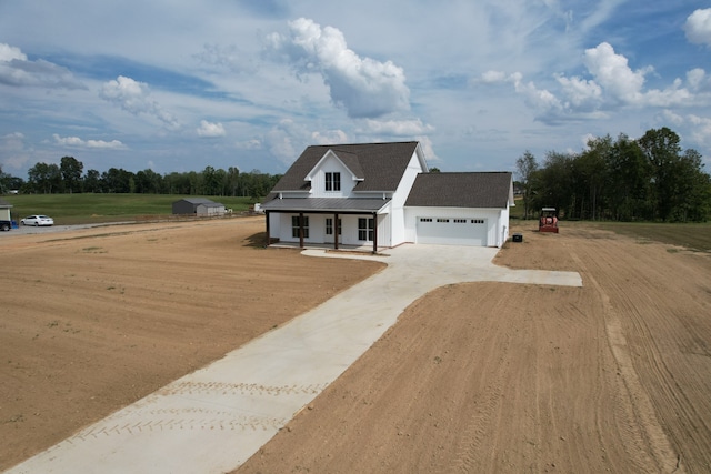 view of front of home with a porch and a garage