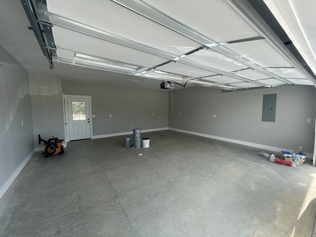 garage with a garage door opener and electric panel