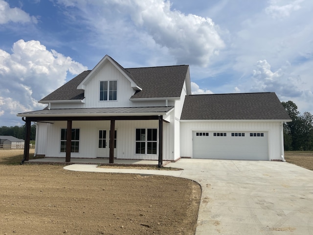 modern farmhouse style home featuring a garage and covered porch