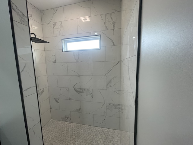 bathroom with a tile shower