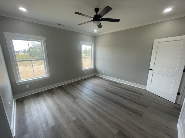 unfurnished room featuring ceiling fan, dark hardwood / wood-style floors, and ornamental molding