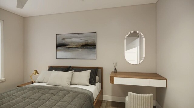 bedroom featuring ceiling fan, wood finished floors, and baseboards