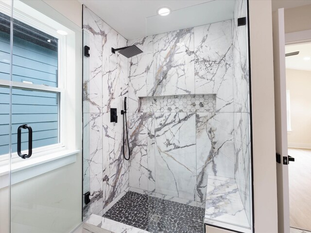 bathroom featuring a marble finish shower