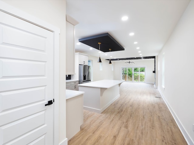 hall with light wood-type flooring, recessed lighting, and baseboards