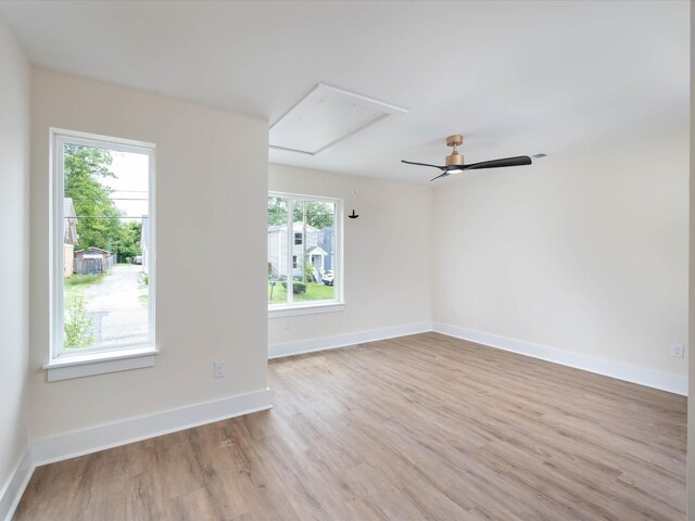 empty room featuring light wood-type flooring and baseboards