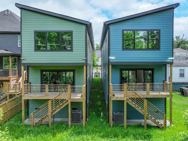 rear view of property with stairway and central AC unit