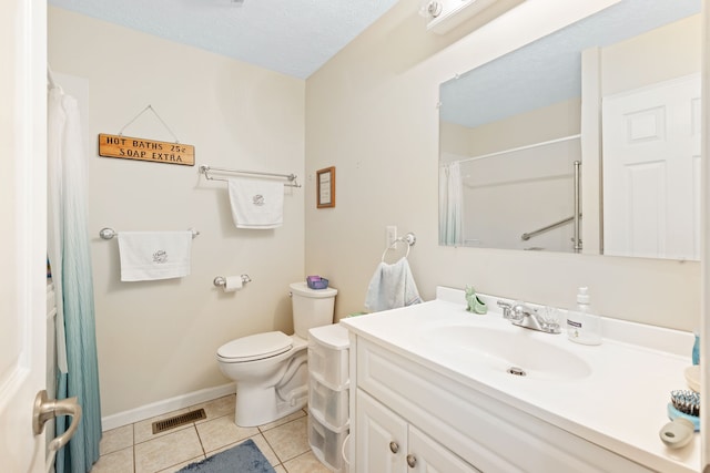 bathroom with tile patterned flooring, vanity, a textured ceiling, and toilet