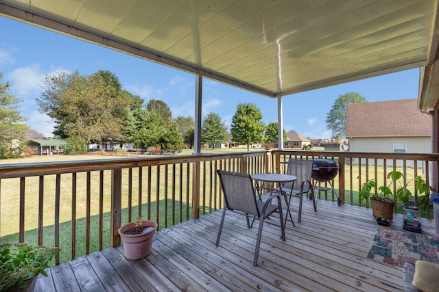 wooden deck featuring area for grilling and a lawn