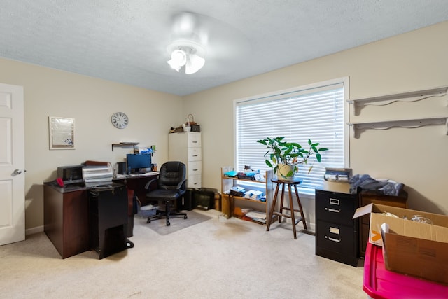 office featuring light carpet and a textured ceiling