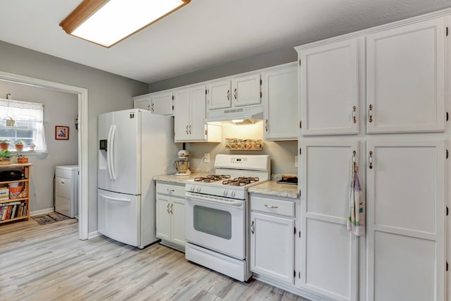 kitchen with white appliances, light hardwood / wood-style floors, and white cabinetry