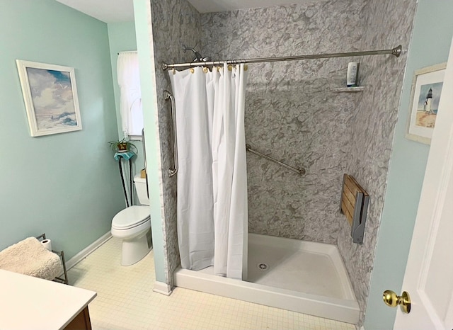 bathroom with tile patterned flooring, vanity, toilet, and curtained shower