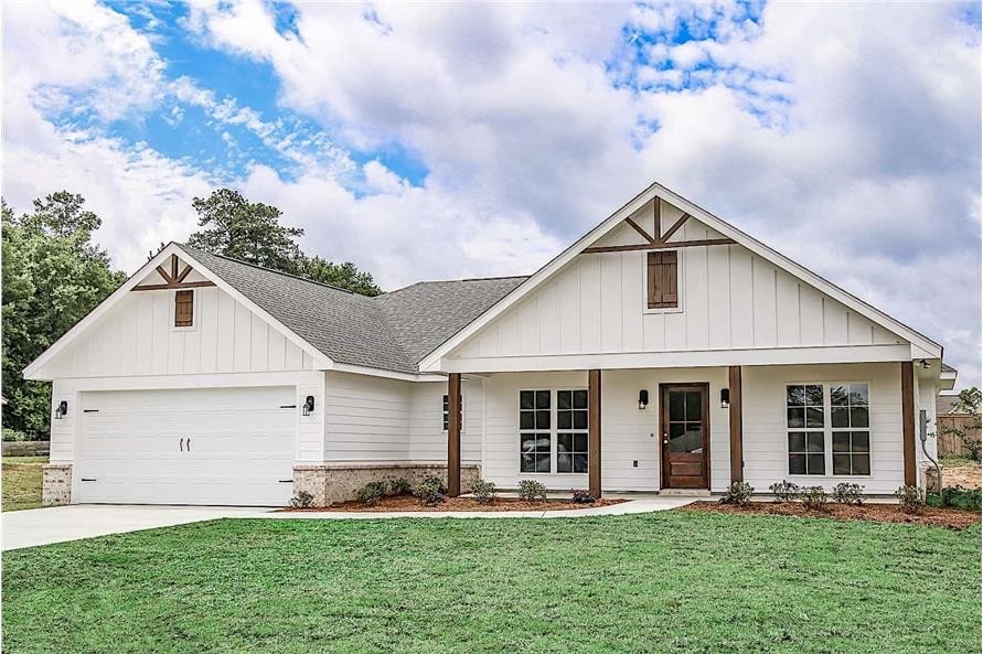 view of front of property featuring a front yard, a garage, and covered porch