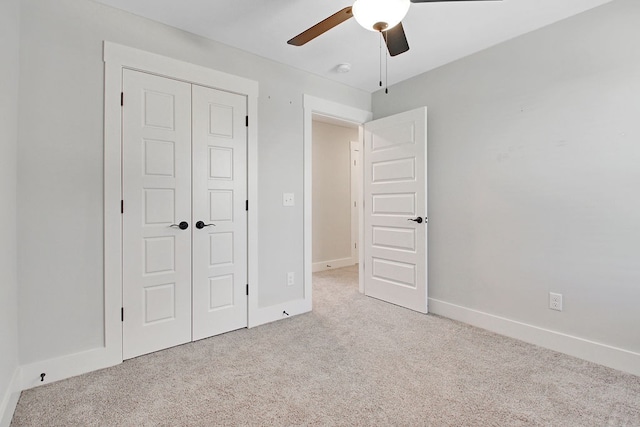 unfurnished bedroom with light carpet, a closet, and ceiling fan