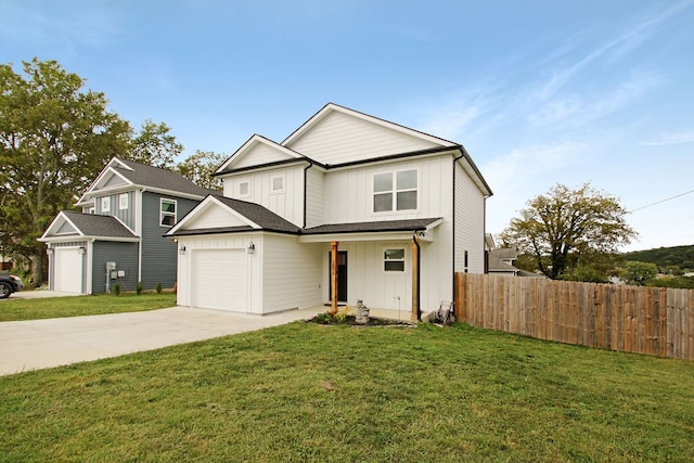 view of front of property with a front yard and a garage