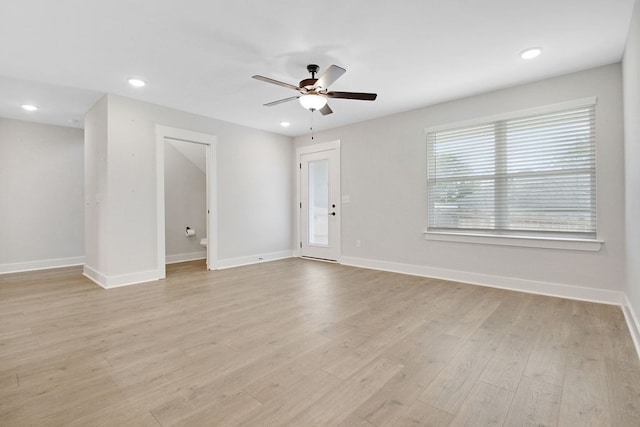 spare room with light wood-type flooring and ceiling fan