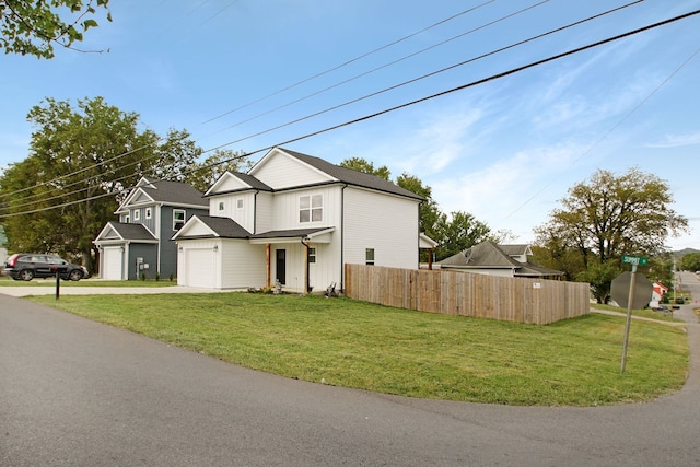 view of front of property with a garage and a front lawn