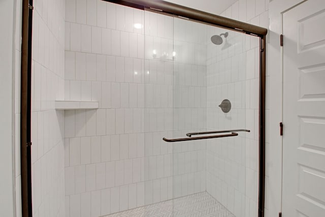 details with a shower with door