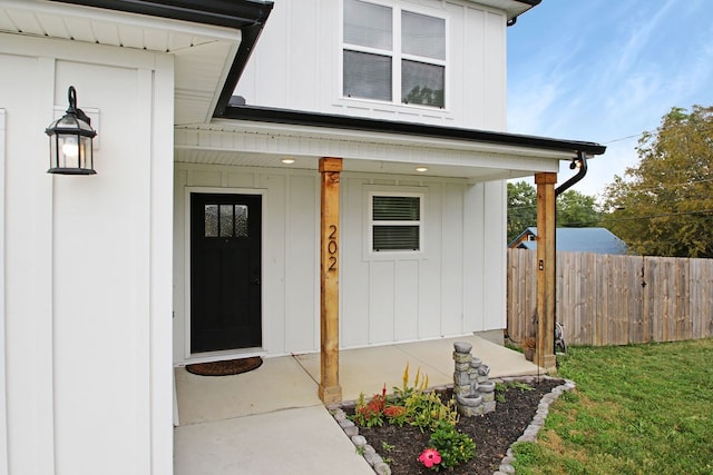 entrance to property featuring a yard