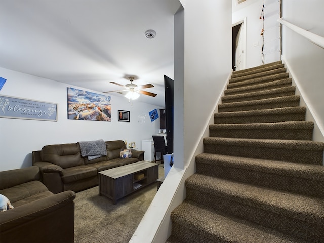 living room featuring ceiling fan and carpet