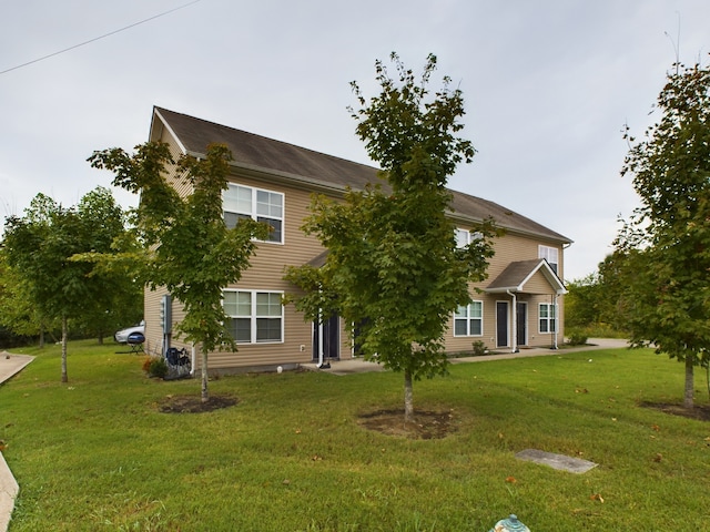 rear view of property featuring a yard