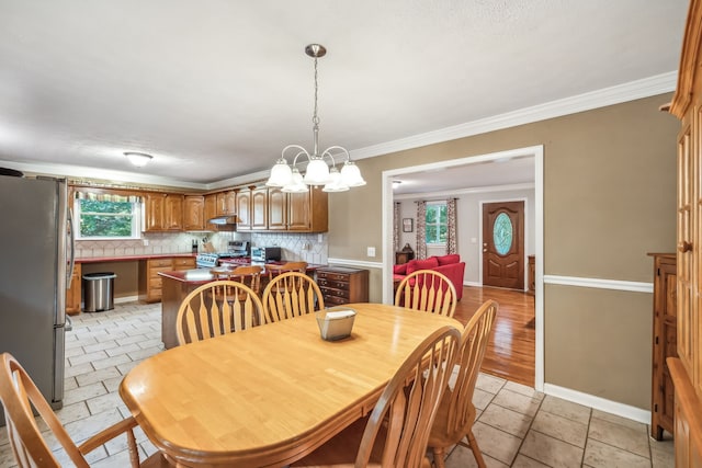 dining area featuring crown molding and a chandelier