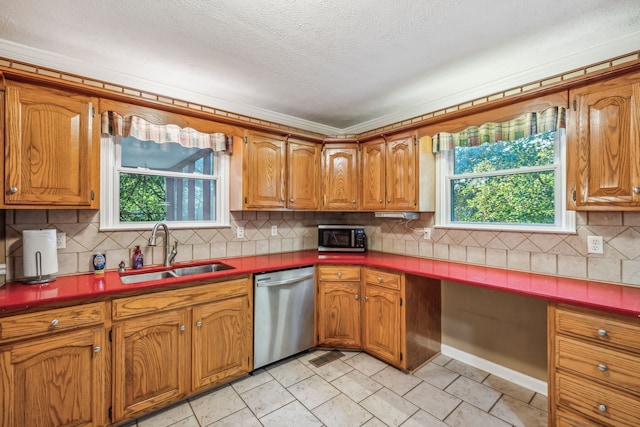 kitchen featuring backsplash, stainless steel appliances, plenty of natural light, and sink