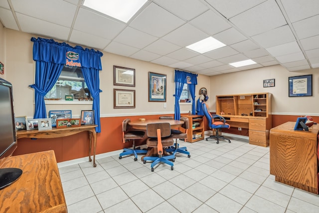 home office featuring a paneled ceiling and tile patterned floors