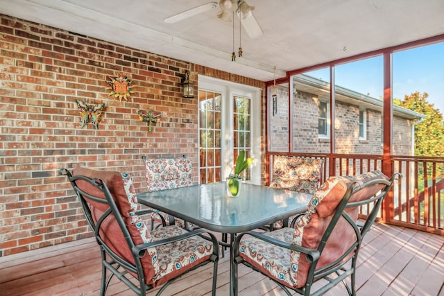 sunroom / solarium featuring ceiling fan