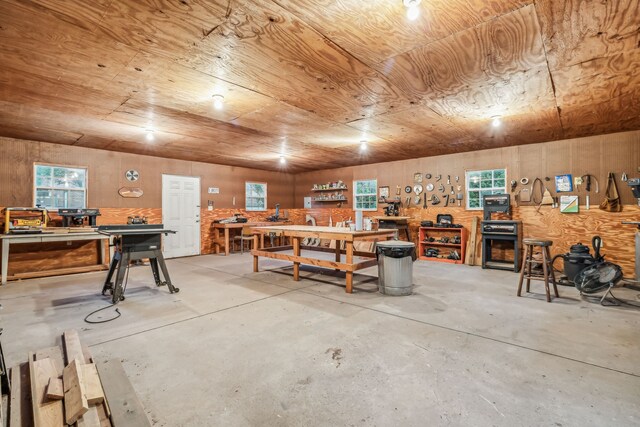 garage featuring a workshop area and wooden ceiling