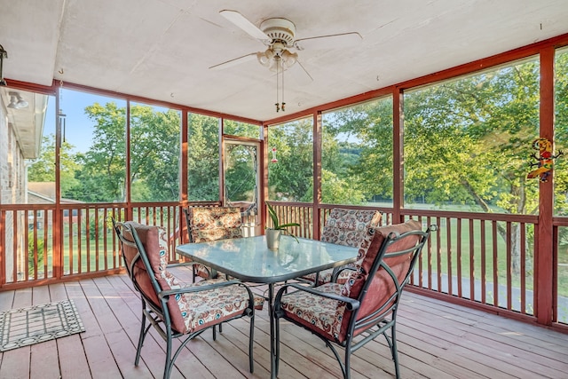 sunroom featuring ceiling fan and plenty of natural light