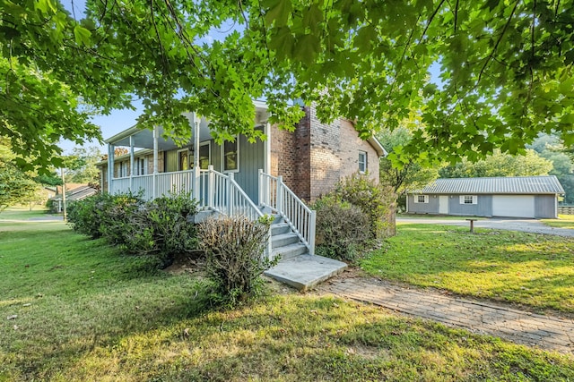 view of front facade with a garage, a front lawn, and a porch